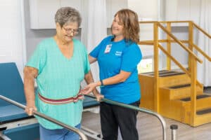 resident being assisted by nurse in rehab facility