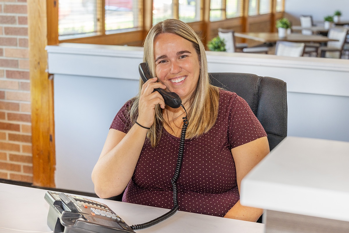 Buckeye Care receptionist smiling while on the phone