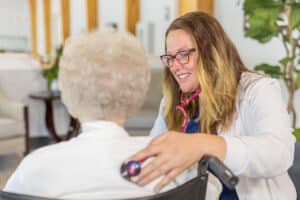 Nurse checking elderly resident's heart beat