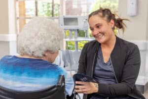 Nurse checking elderly resident's vitals