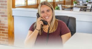 Buckeye Care receptionist smiling while on the phone